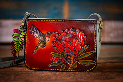 Unique Fossil Upcycled Light Blue Leather Crossbody: Artistic Hummingbird & Protea Design with Fern Charm - Lotus Leather