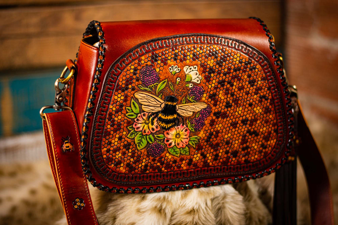 Handmade genuine leather bag with wood burned honeycomb and bee details on hardwood good sides